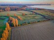 © Ronnies-creatives/Wirestock Creators - Aerial view of waterside agricultural fields at sunset in Suffolk
