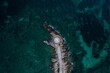 © Dimitris Zografos/Wirestock Creators - Aerial view of sea waves breaking rocky beach
