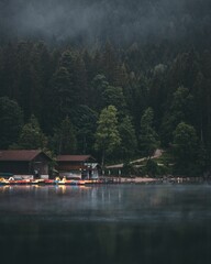 Canvas Print - Vertical shot of wooden houses on the shore of Lake Eibsee in Bavaria, Germany