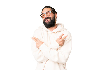 Wall Mural - Young man with beard over isolated chroma key background smiling and showing victory sign