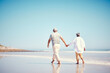 © Jesse Bettencourt/peopleimages.com - Holding hands, beach and an old couple walking outdoor in summer with blue sky mockup from behind. Love, romance or mock up with a senior man and woman taking a walk on the sand by the ocean or sea