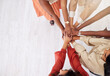 © Nina Lawrenson/peopleimages.com - Business people, hands together and diversity with team top view, collaboration and support with solidarity in workplace. Mockup space, women working together and teamwork with professional group