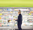 © lado2016 - supermarket shopping,Woman choosing a dairy products at supermarket.