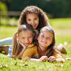 Wall Mural - .Summer, girls portrait or happy kids on grass in park together for fun, bonding or playing in nature. Smile, diversity or young best friends smiling or embrace on school holidays in outdoor field.