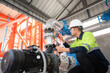 © เลิศลักษณ์ ทิพชัย - Asian male industrial engineer working inspect water systems and water tank systems in engineering plants, utilities, sewer and industrial wastewater treatment plants.