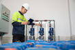 © เลิศลักษณ์ ทิพชัย - 1 male industrial engineer controlling chemical systems and inspecting water systems in engineering plants. utility water system sewers and wastewater treatment plants