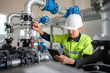 © เลิศลักษณ์ ทิพชัย - A male industrial engineer Controlling the operation of water pipes and water systems in engineering plants. Utilities Water storage pipes and wastewater treatment plants