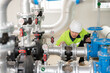 © เลิศลักษณ์ ทิพชัย - Asian male industrial engineer working Inspection and maintenance of factory water storage tanks or water systems in engineering plants.