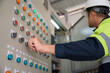 © เลิศลักษณ์ ทิพชัย - Close-up shot of industrial engineer hand pressing industrial power control button in engineering factory