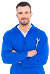 Wall Mural - Happy mechanic holding spanner on white background