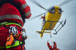 Selective focus on safety harness of paramedic of emergency service in front of helicopter. Themes rescue, help and hope..
