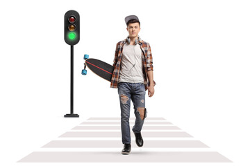 Sticker - Full length portrait of a male skater with a longboard walking towards the camera at a pedestrian crossing