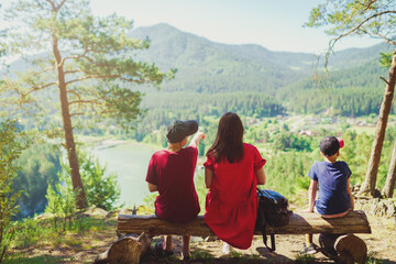 Sticker - mother and two sons sitting on the bench on the top of hill 