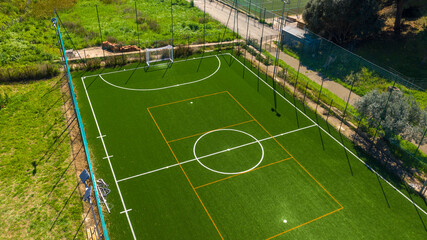 Wall Mural - Aerial view on an artificial turf soccer field with synthetic grass during a sunny day