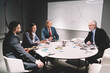 © BullRun - Group of colleagues discussing business strategy in conference room