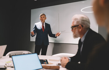 Wall Mural - Elegant businessman making presentation in office