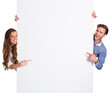 Happy young couple with blank board