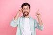 Photo of young funny guy wear shirt point finger up solution eureka finger point up touch glasses isolated on pink color background