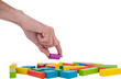 Cropped hand arranging plastic blocks