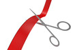 Metal scissors cutting red ribbon