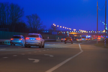 Wall Mural - car traffic in the evening on a suburban highway.