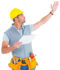 Wall Mural - Male supervisor with hand raised holding clipboard