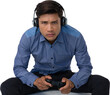 Portrait of young businessman wearing headphones while playing video game