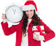 Festive brunette holding a clock and gift