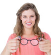 Portrait of smiling woman holding black eyeglasses 