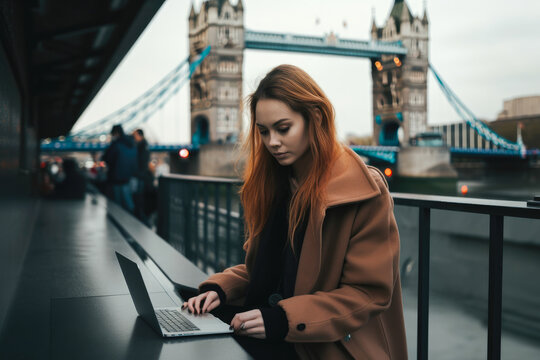 Young woman sitting in London and doing work on laptop. Student or freelancer lifestyle. Tower Bridge in the background. High quality generative ai