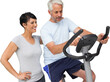 Happy woman looking at mature man on stationary bike
