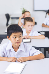 Poster - Schoolboy sitting in classroom