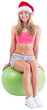 Festive fit blonde sitting on exercise ball