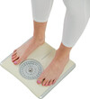 Low section of woman standing on weighing scales