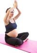 Pregnant woman meditating in lotus pose with arms raised