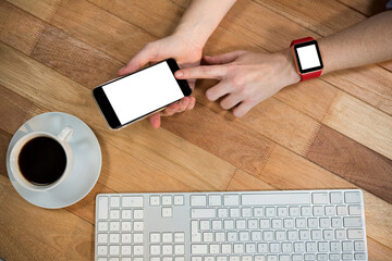 Poster - Overhead view of businesswoman with smart watch using mobile phone