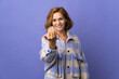 © luismolinero - Young Georgian woman isolated on purple background inviting to come with hand. Happy that you came