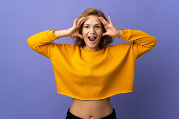 Young Georgian woman isolated on purple background with surprise expression