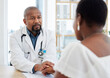 © Nina Lawrenson/peopleimages.com - Serious doctor, patient and holding hands in consultation for bad news, cancer diagnosis or comfort. Healthcare, black man and medical professional with woman for help, support and empathy in clinic.