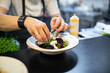 © pavel siamionov - professional chef's hands cooking beetroot salad with feta cheese in a restaurant kitchen