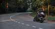 © perfectlab - Blurred Motion A young man biker in a helmet quickly rides at high speed on a forest road, in motion