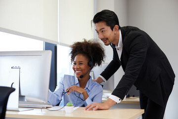 businessman or supervisor training and suggesting about work to colleagues at call center service in the office