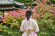 Asian woman wearing a pink traditional hanbok dress in Changdeokgung Palace, Seoul, South Korea
