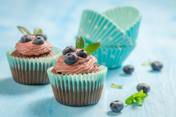 Wall Mural - Delicious homemade cupcake with chocolate cream and blueberries.