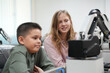 © FotoArtist - Children learning AI technology Robot with artificial intelligence system on its about the artificial intelligence during science lesson.