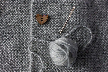 Close up of knitted sweater for newborn.