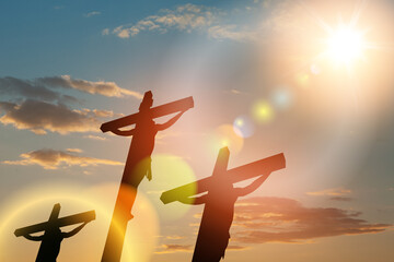 Wall Mural - Silhouette of the crucified Jesus Christ on the cross along with other people on background of sunset