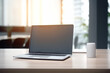 © MASmaker - A blank screen laptop on a office desk. soft sunlight in background. Laptop screen mockup