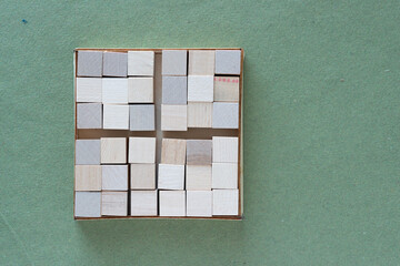 Poster - box of wood cubes on rough green paper