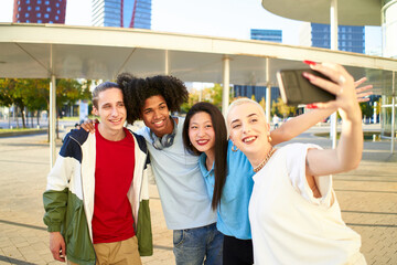 Wall Mural - Happy centennial people taking smiling selfie. Group of students together at campus university . High quality photo